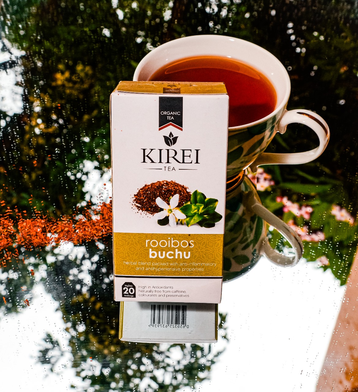 A cup of Kirei rooibos tea on a wooden counter in warm morning light